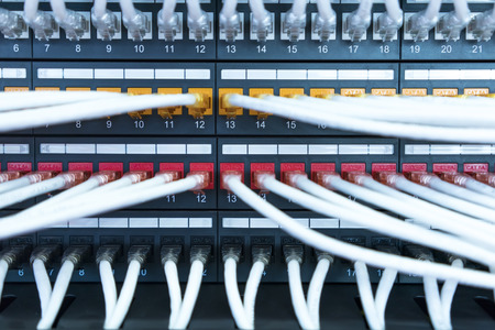 network cables and hub closeup with fiber optical background