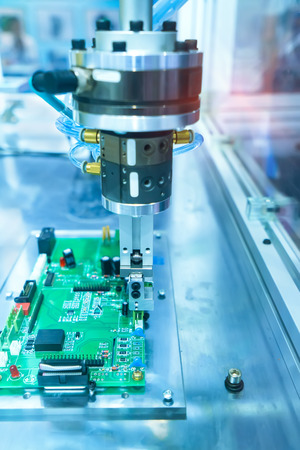 soldering iron tips of robotic system for automatic point soldering for printed and assembly electric circuit board ( PCB ) at factoryの写真素材