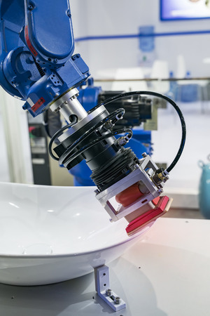 robot arm is working smartly in sink department in artificial intelligence factoryの写真素材