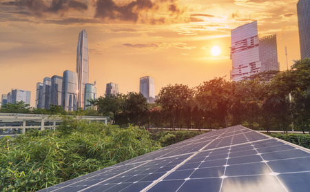 Ecological energy renewable solar panel plant with urban landscape