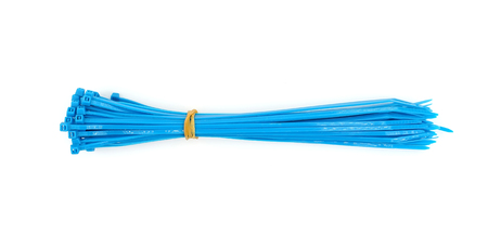 blue plastic nylon cable ties closeup on white backgroundの写真素材