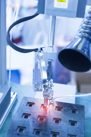 automatic soldering iron tips of robotic system for printed and assembly electric circuit board ( PCB ) at factoryの写真素材