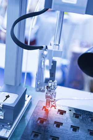 automatic soldering iron tips of robotic system for printed and assembly electric circuit board ( PCB ) at factoryの写真素材
