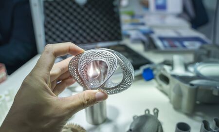 hand with Object printed on 3d printer close-up.