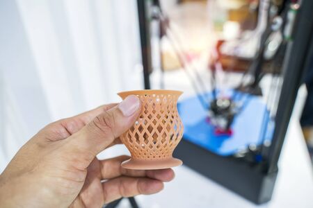 hand with Object printed on 3d printer close-up.