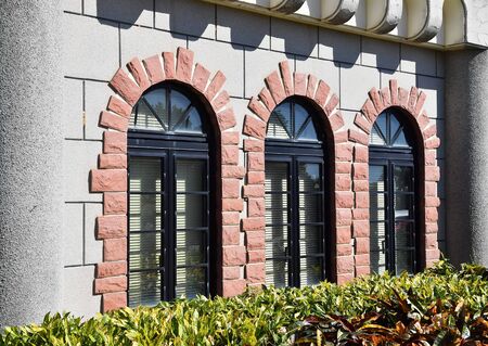 Windows with an arch on the facade of wallの写真素材