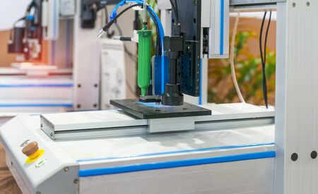Robot holding glue syringe Injection with robotic machine vision systemの写真素材