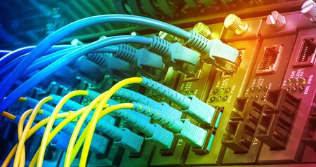 Fiber Optic cables connected to optic ports and UTP, Network cables connected to ethernet ports.