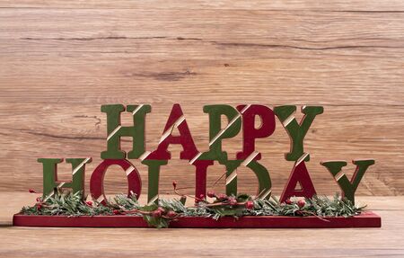 happy holiday board on wooden backgroundの写真素材