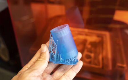 hand with Object printed on 3d printer close-up.
