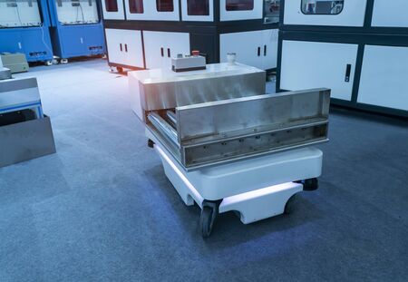 warehouse robot car carries cardboard box assembly in factory