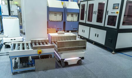 warehouse robot car carries cardboard box assembly in factory