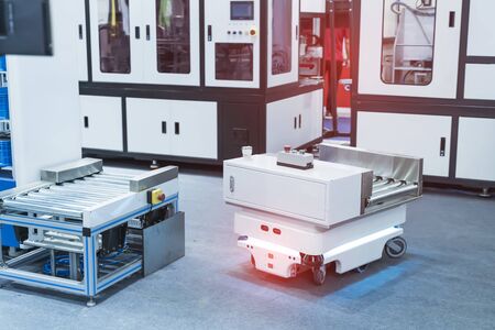 warehouse robot car carries cardboard box assembly in factory