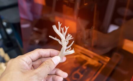 hand with object in shape of medically accurate a human blood vessel printed on 3d printerの写真素材