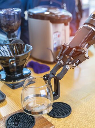robotic arm preparing coffee in coffee machineの写真素材