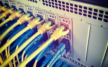 Fiber Optic cables connected to an optic ports and Network cables connected to ethernet ports