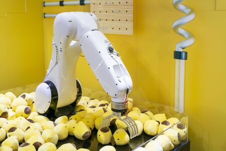 robotic toy crane on funfair with soft toys in itの写真素材