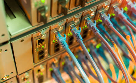 Fiber Optic cables connected to an optic portsの写真素材