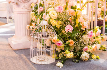 wedding decoration with beautiful vintage birdcage and flowers.の写真素材