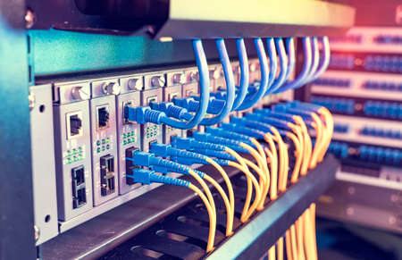Fiber Optic cables connected to an optic ports and Network cables connected to ports