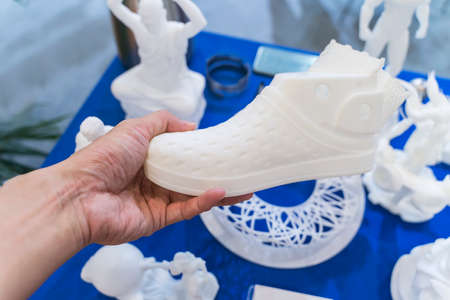 hand with 3d printed shoe figure close-upの写真素材