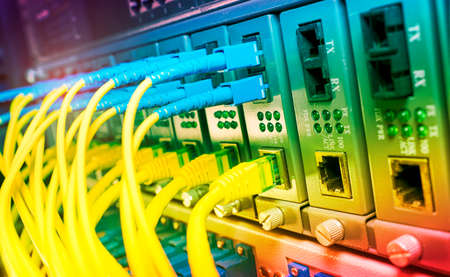 Fiber Optic cables connected to optic ports and UTP and Network cables connected to ethernet ports