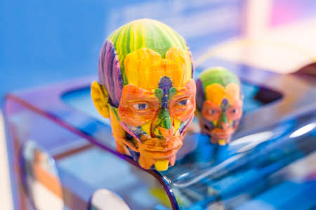 model printed on 3d printer in form of colorful skull, additive technologies and futuristic concept