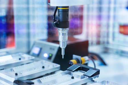 automatic robot drill machine tool at mobile industrial manufacture factoryの写真素材