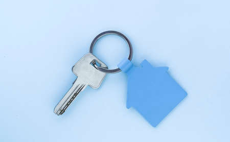 key chain with house symbol and keys on green background,Real estate conceptの写真素材