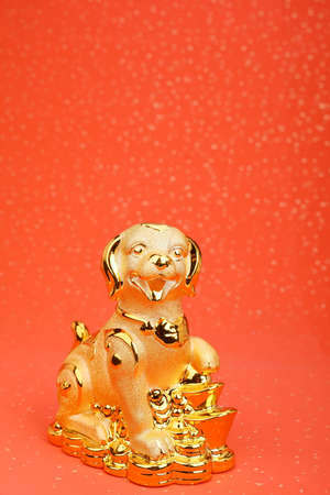 Chinese new year decoration:golden dog statue,translation of calligraphy: good Fortune for moneyの写真素材