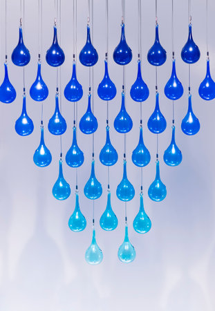 Blue glass bubble decoration tied rope hanging on ceilingの写真素材