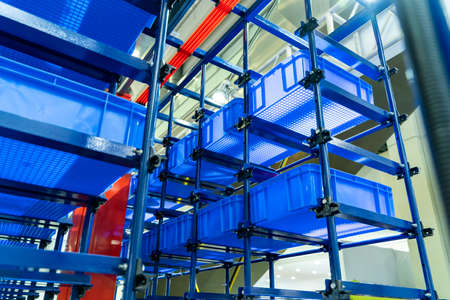 plastic boxes in the cells of the automated warehouse. Metal construction warehouse shelvingの写真素材
