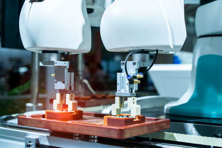 robotic arm catch for electronic assembly line. The robot for smart technology manufacturing...