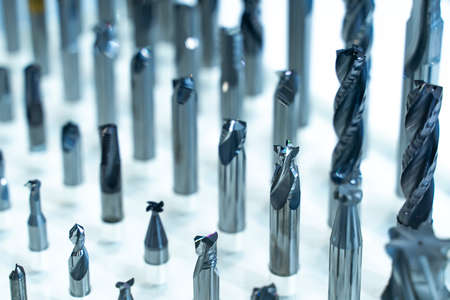 automatic heavy industrial drill bit cutting the metal block at the factory
