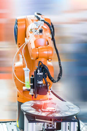 automaitc holding glue syringe Injection in mobile phone factory with robotic machine vision system