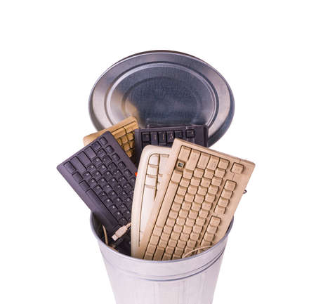 different computer keyboards in trash canの写真素材