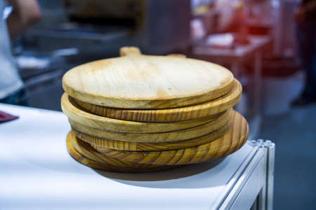stack of empty round cutting pizza wooden pansの写真素材