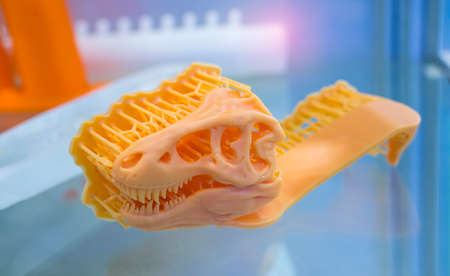 3D printer printing dragon head figure close-up