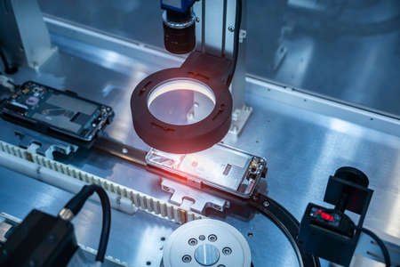 artificial intelligence machine with camera sensor working in mobile phone factoryの写真素材