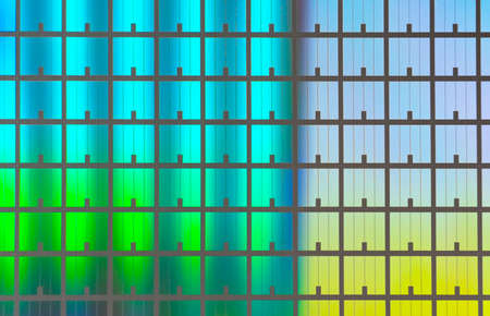 silicon chip wafer reflecting different colorsの写真素材