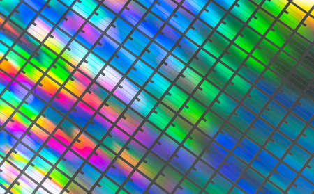 silicon chip wafer reflecting different colorsの写真素材