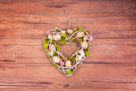 Easter eggs, branches and spring leaves. Heart shape. floral wreath for Easterの写真素材