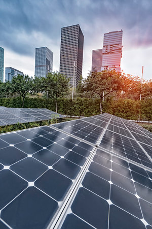 Ecological energy renewable solar panel plant with urban modern building landscape landmarksの写真素材