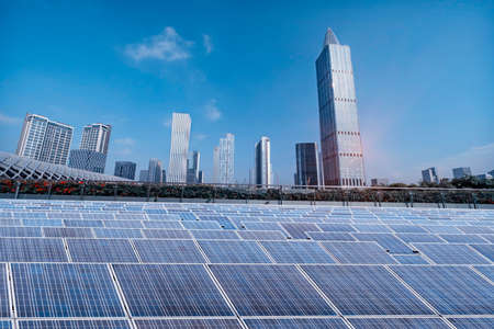 Ecological energy renewable solar panel plant with urban landscape landmarksの写真素材