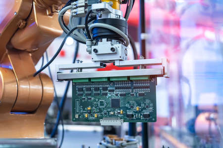 automatic robot for print circuit board (PCB)assembly machine during soldering or welding part at factoryの写真素材