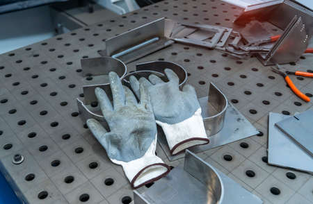 Welding gloves and machine metal in the workshopの写真素材