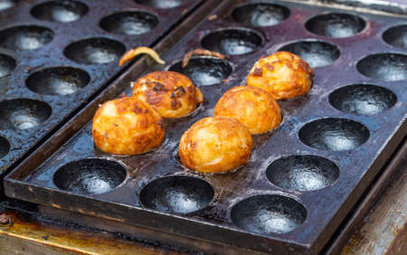 Close up of Takoyaki, octopus balls On Hot Panの写真素材