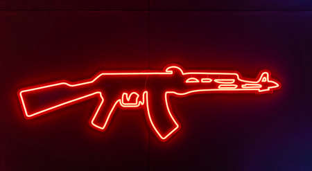 Glowing neon line weapon gun icon isolated on blue background