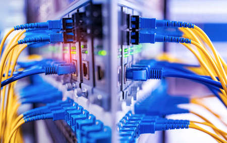 Fiber Optical cables connected to optic ports and Network cables connected to ports