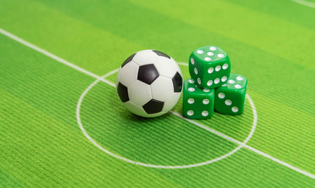 dice and soccer ball on green grass, football sports betting concept